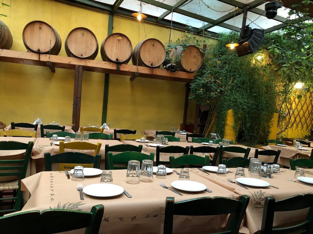 interior of Klimataria restaurant with tables and wine barels